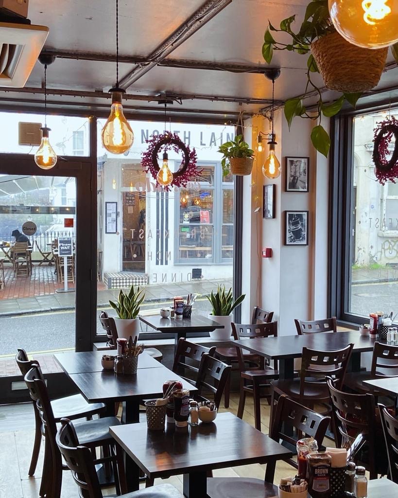 The warm, Edison-lit dining room of Caffè Aldo on Trafalgar Street